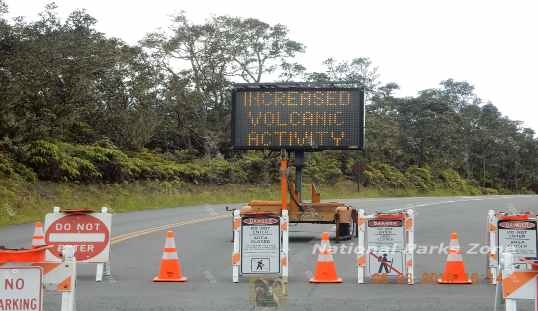 Picture of closed park entrance with sign saying 'Due to Increased Volcanic Activity' (companion to 'Park Closed' sign)